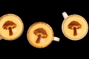 Cups of coffee with mushrooms on top