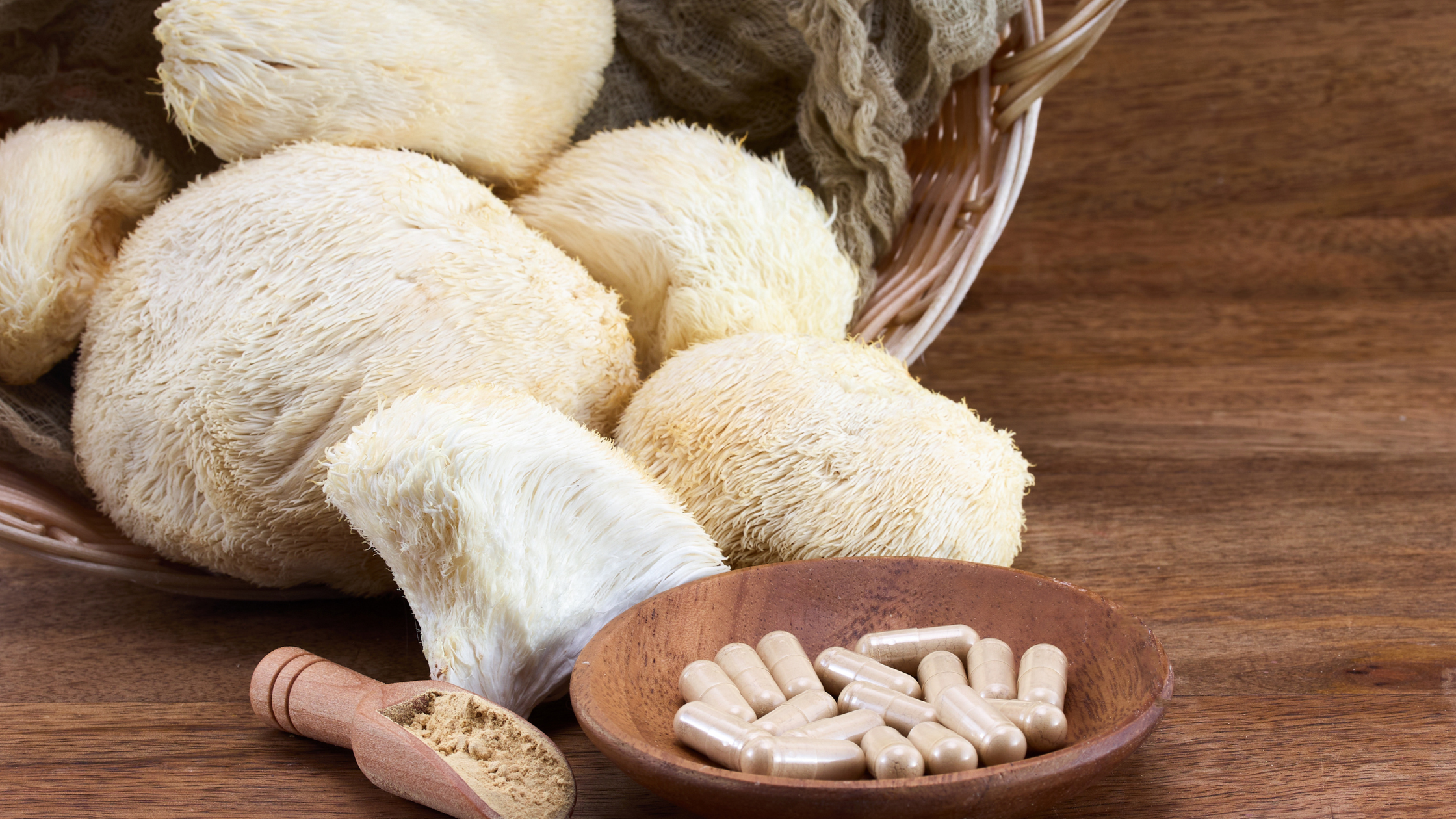 Lion's Mane Mushrooms with capsules and powder in front.