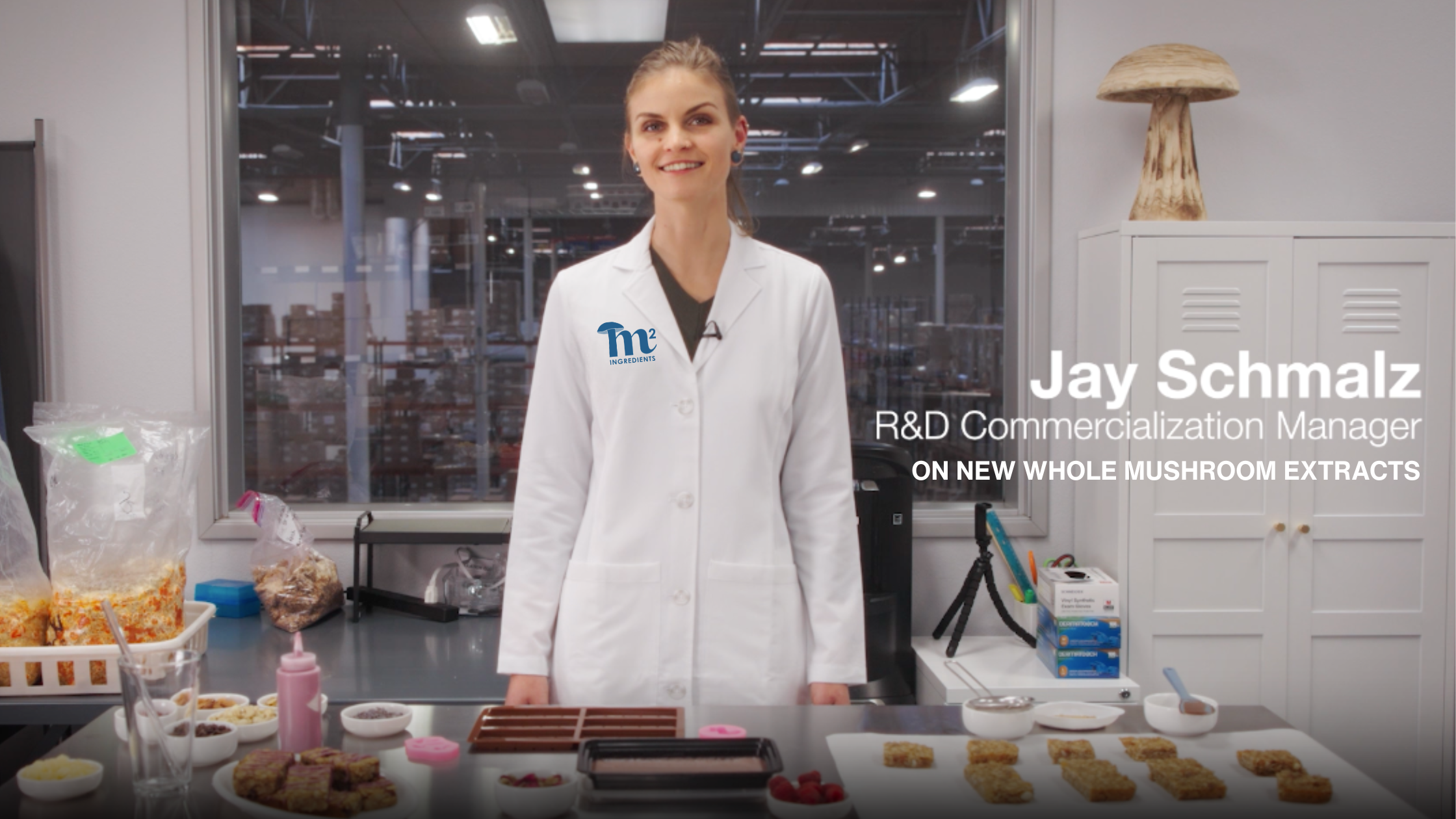 Jay is standing in a lab coat in a food science lab showcasing that mushroom ingredients can be incorporated into a wide variety of applications.